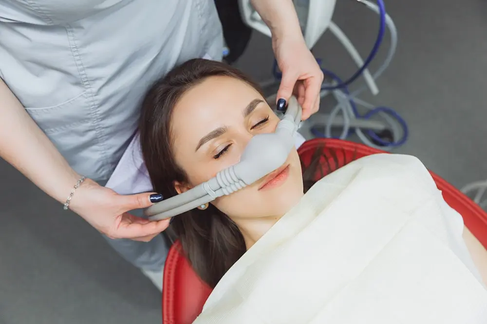 Woman receiving nitrous oxide sedation at the dentist for comfortable, stress-free treatment