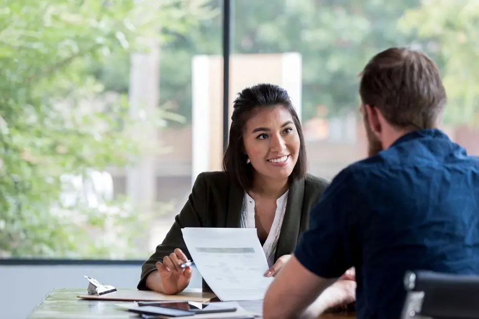 Cheerful-businesswoman-meets-with-client Cheerful businesswoman meets with client