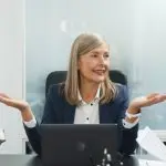 Lawyers discussing documents around a conference table in an office