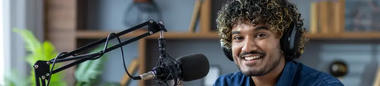 Man creating a podcast, talking into a mic