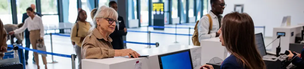 Senior woman checking in at an airport