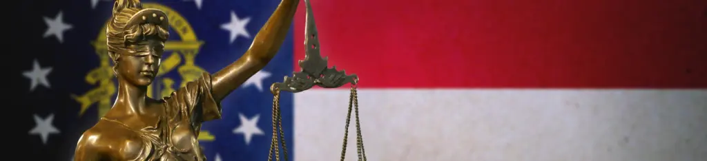 Justice statue in front of a United States of America flag