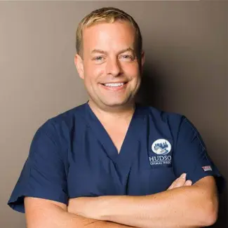 Professional portrait of Customer Service Representative Robert Cleveland wearing a Hudson Animal Hospital scrub top.