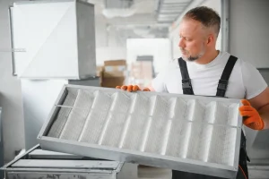 Contractor replacing an air filter