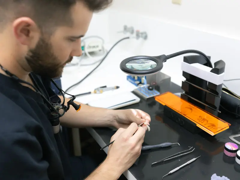 Dr. Jaden Danos handling dental instruments at workstation in Danos Dental in Murfreesboro, TN