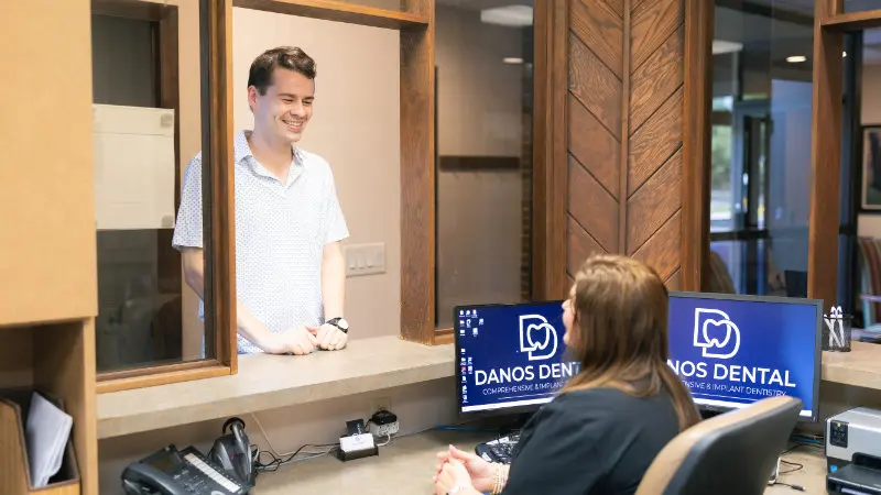 Front desk team greeting new patient at Danos Dental in Murfreesboro, TN