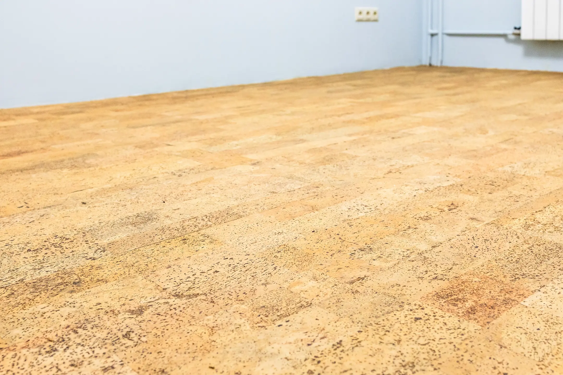 freshly laid brown cork tile flooring in room during home renovation