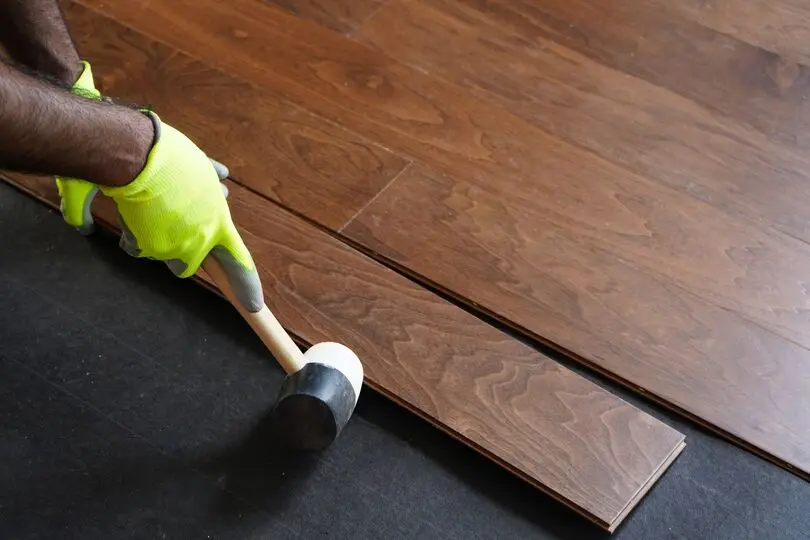 Worker installing hardwood floors