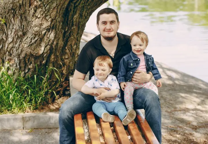 Young and beautiful father with a child in the summer park