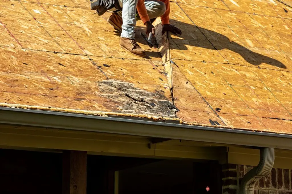 attic vent installation worker fixing wood planks