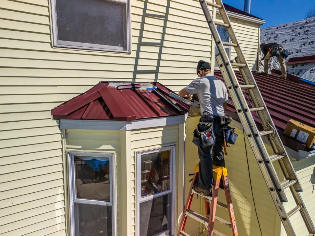 gaf timbersteel red metallic roof light yellow siding