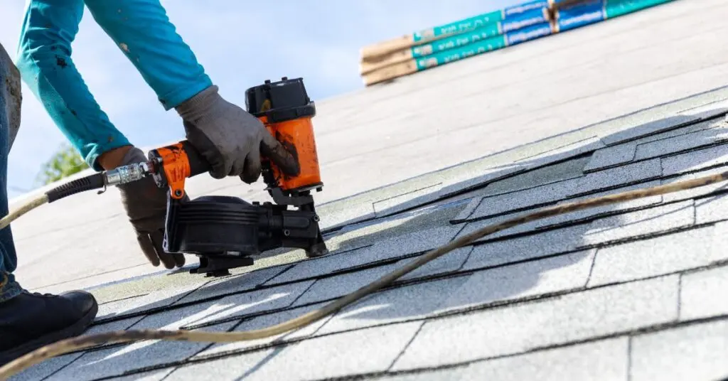 wind damage to roof person changing roof tiles
