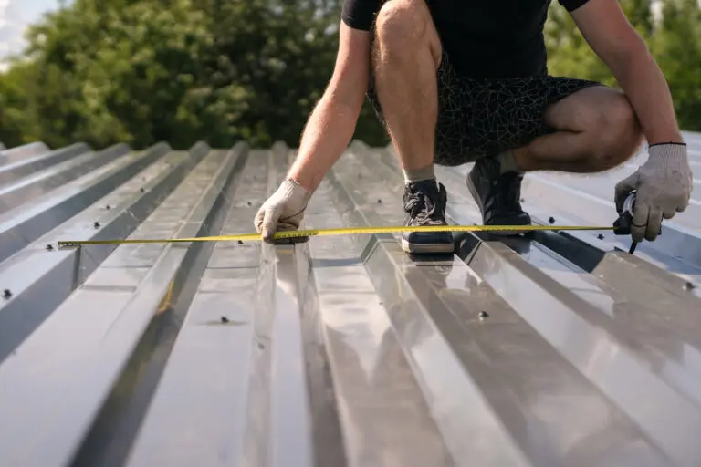 how to measure a roof for metal roofing The builder measures the width of the corrugated sheet on the roof with a tape measure