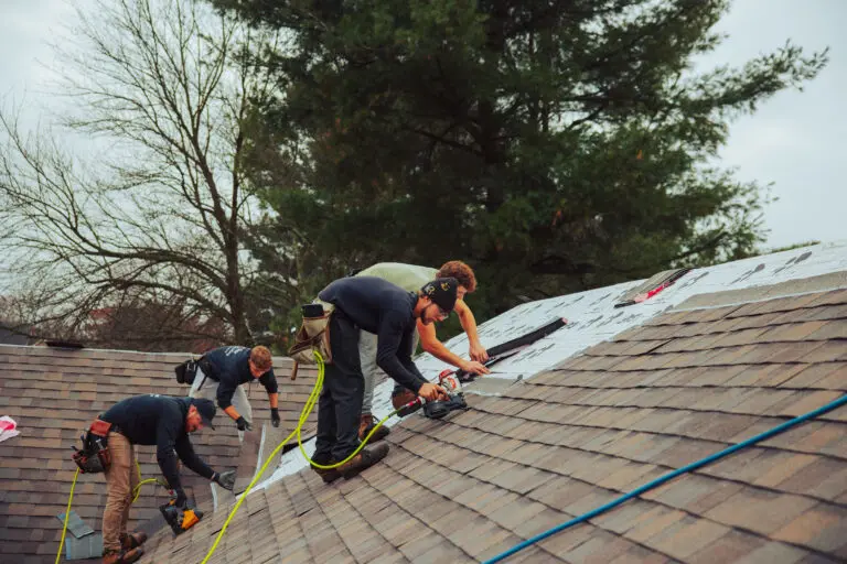 does home insurance cover roof repair Keim workers repairing shingles