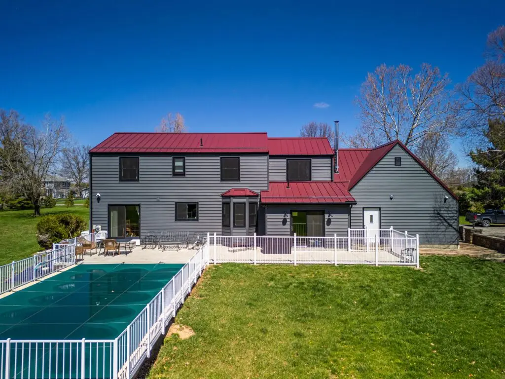 minimum slope for a metal roof grey siding red metallic roof