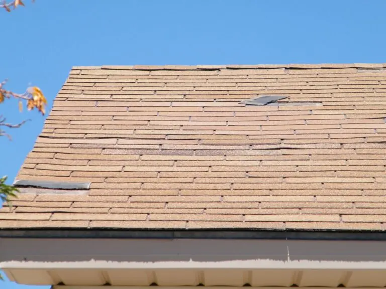 curling shingles orange roof shingles falling blue sky summer time