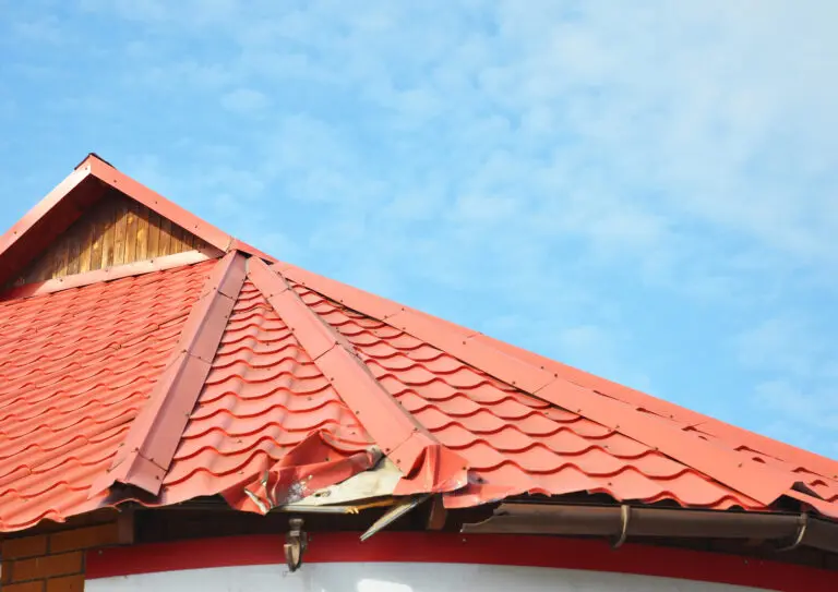metal roof repair Close up on Broken Metal Roof and Rain Gutter. Damaged Roof.
