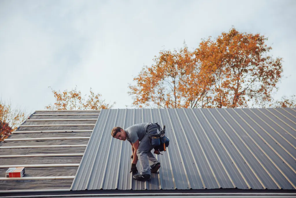 metal roof colors worker installing new metallic roof