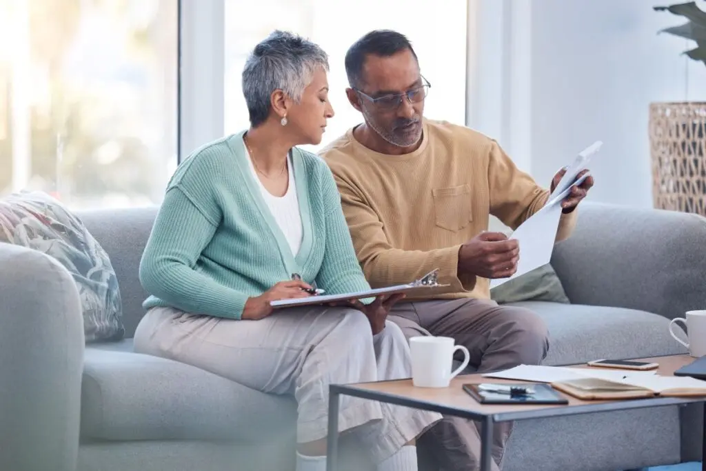 roof insurance claim old couple reading papers