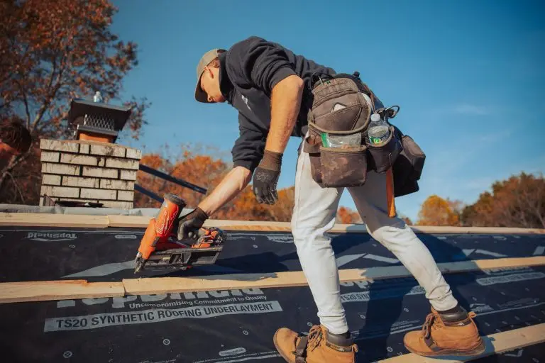 guy installing wooden roof part