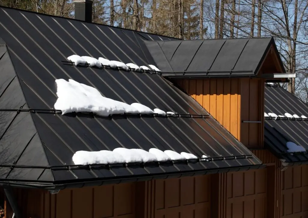 metal roof accents snow on top of guards 