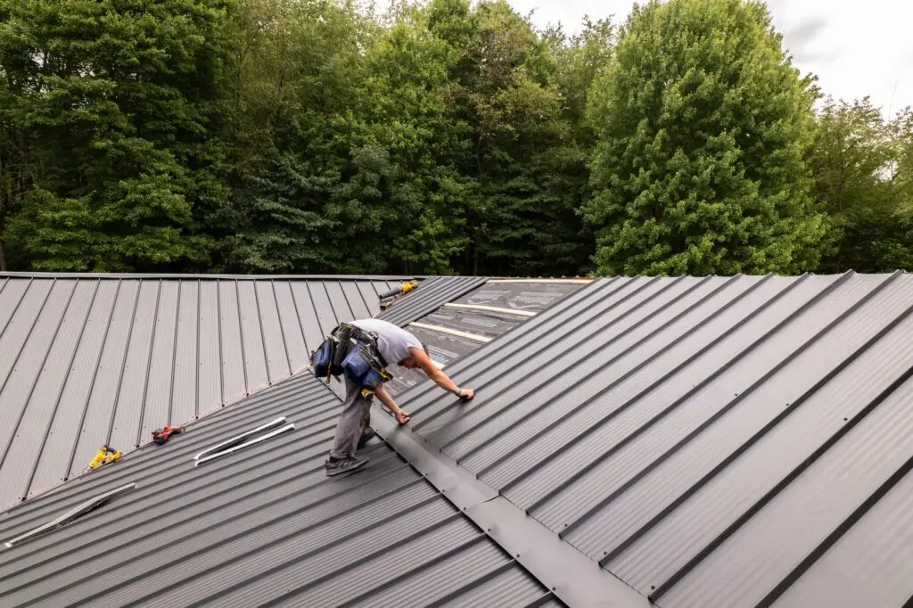 minimum slope for a metal roof worker installing grey metallic roof