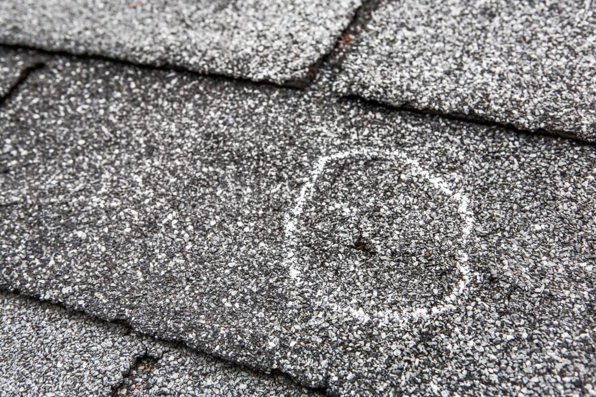 what does hail damage look like on a roof shingle with a hole after storm