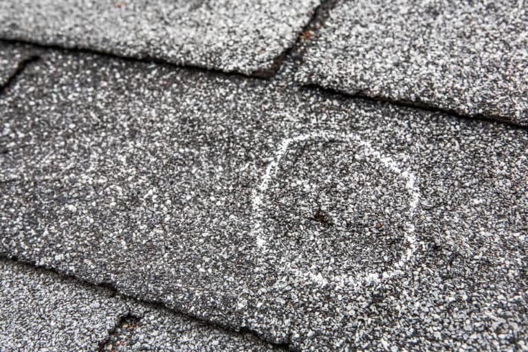 what does hail damage look like on a roof shingle with a hole after storm