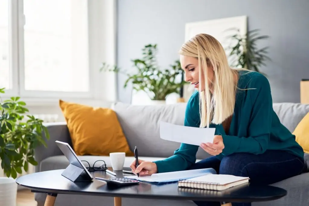 storm damage roof insurance claim woman smiling filling papers