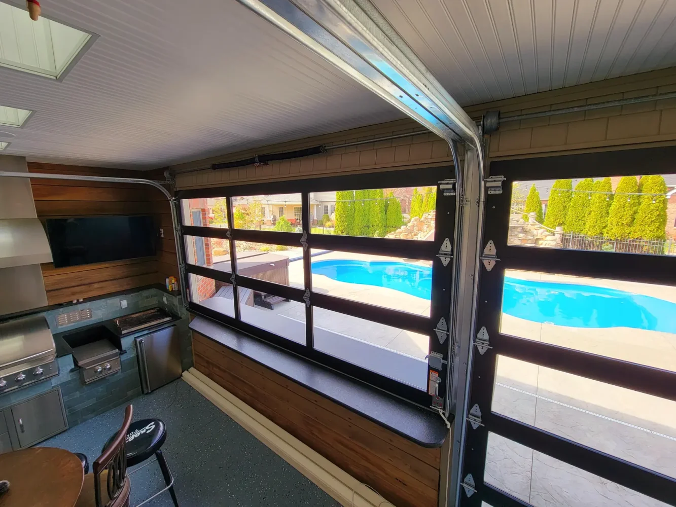black-full-view-glass-garage-door-poolside-interior-chesapeake-va