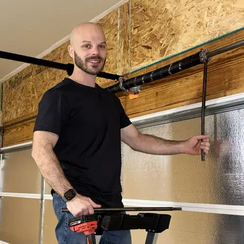 Swift Lift STL founder Brian Eyster repairing a garage door