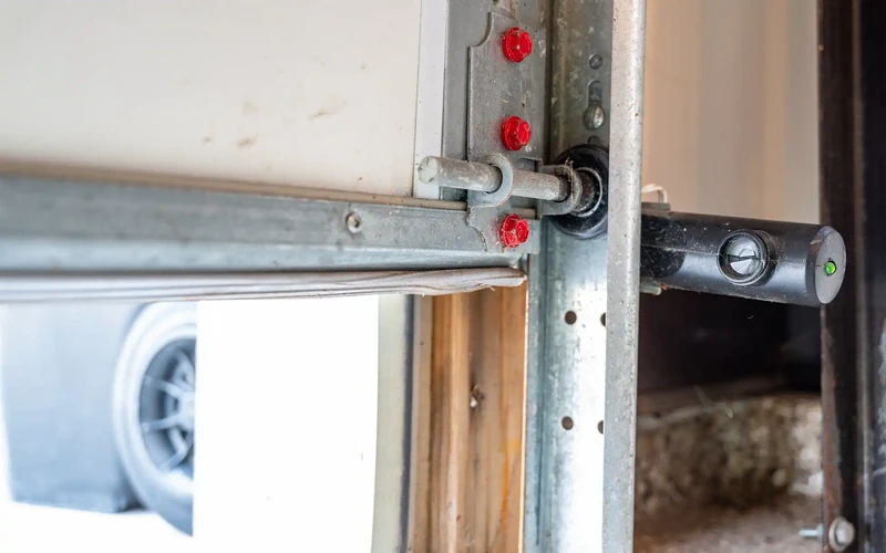 Garage door track roller assembly replacement service