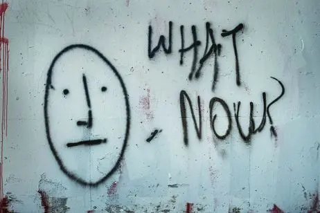 Photo of graffitti with a COVID message, "what's now?"
