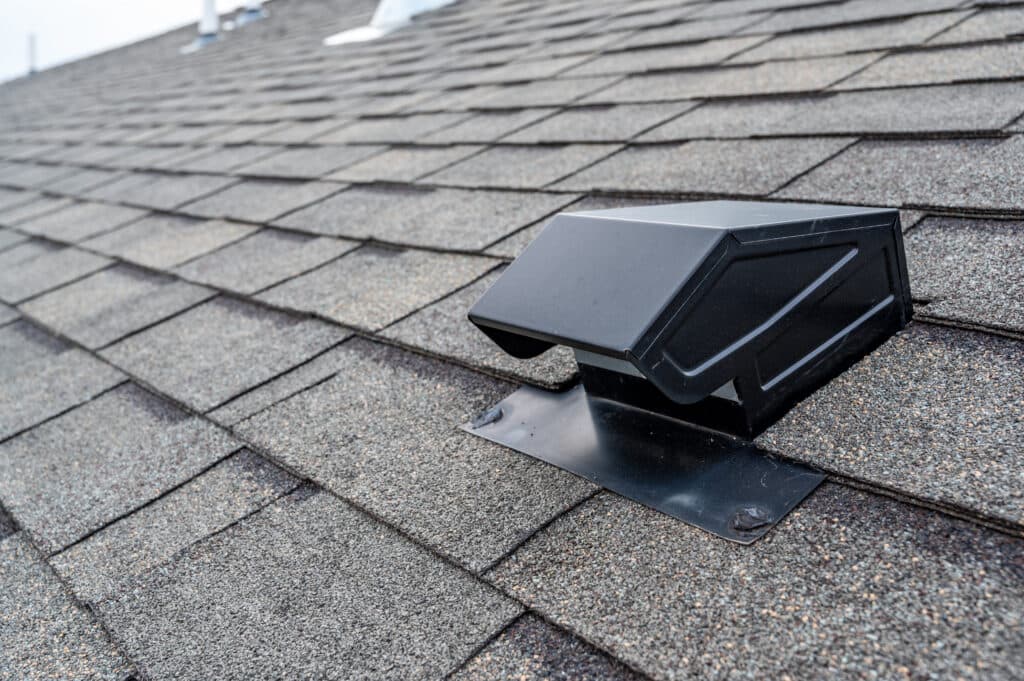 roof vents Roof of commercial building with exhaust vent.