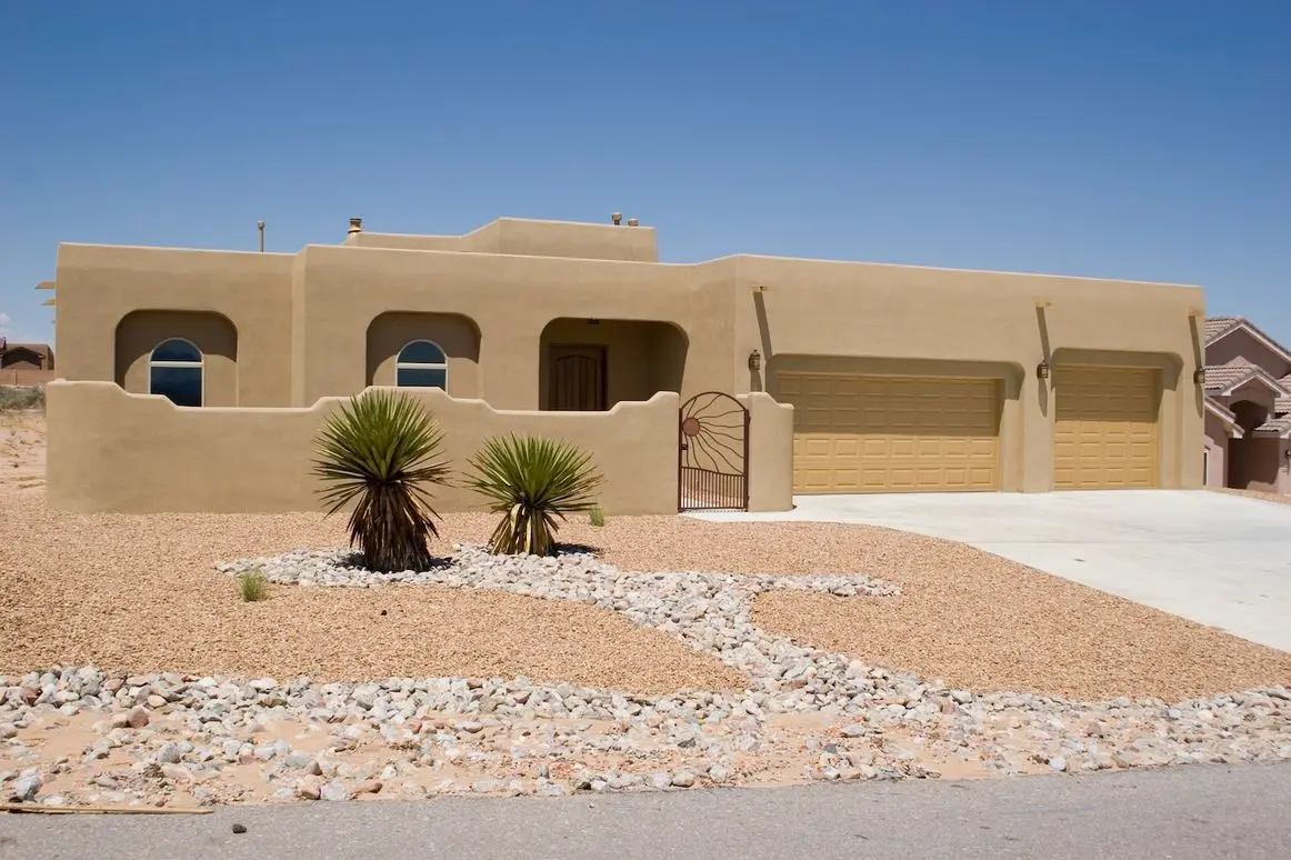 southwestern style house with rock garden landscaping
