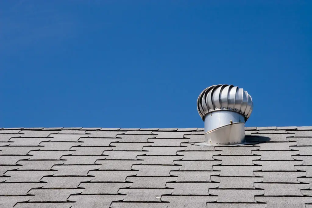 roof vents Roof of commercial building with exhaust vent.