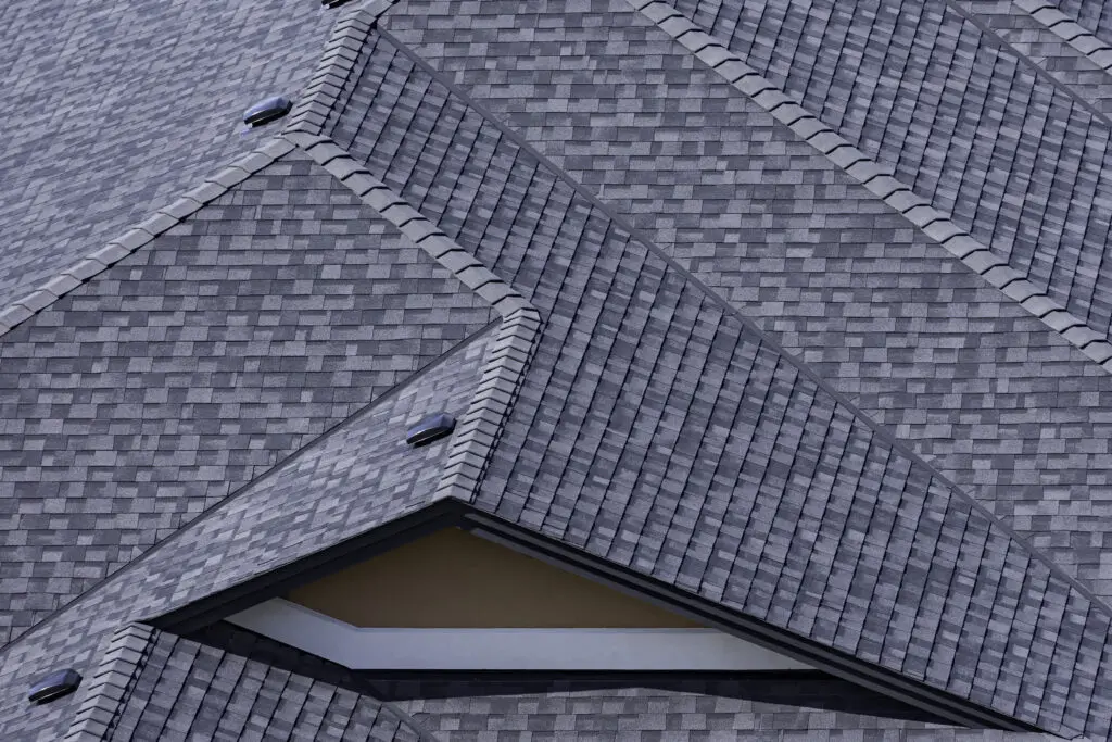 Rooftop in a newly constructed subdivision in Kelowna British Columbia Canada showing asphalt shingles and multiple roof lines