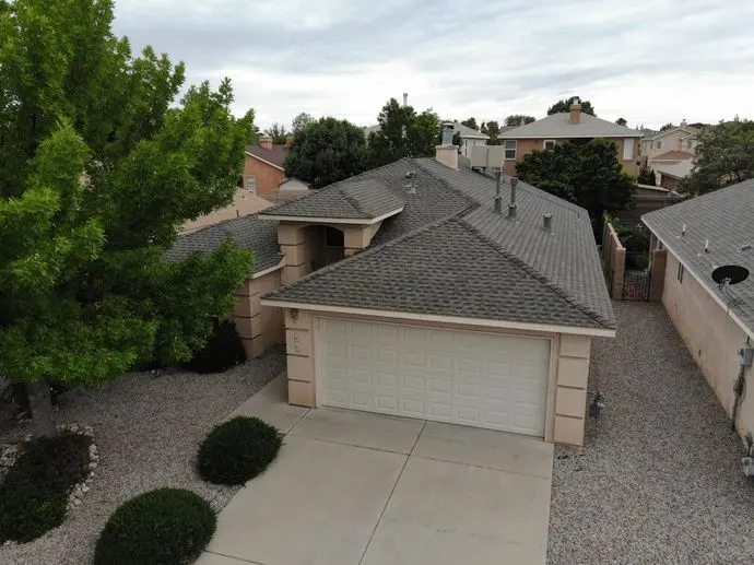 a house with a driveway and trees