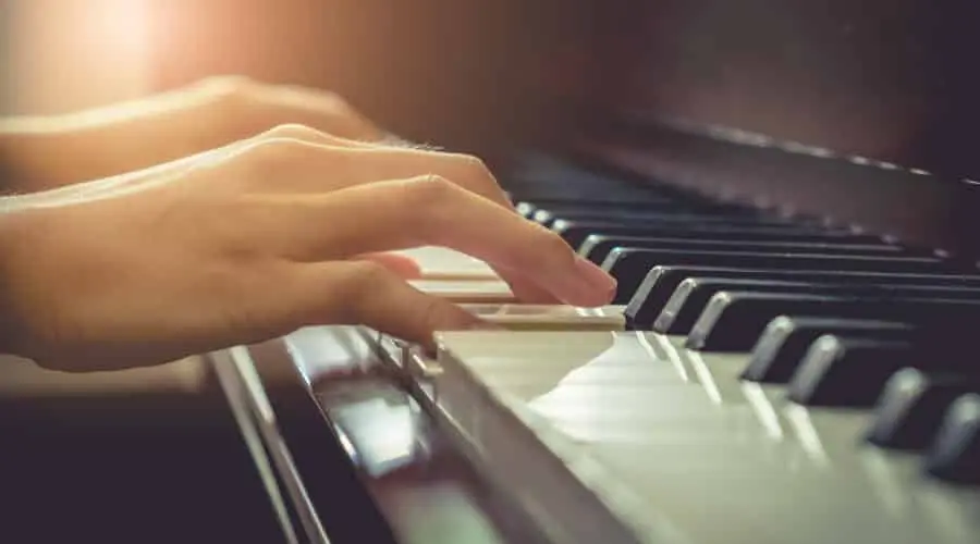 Musician playing piano in chruch with vintage filter.