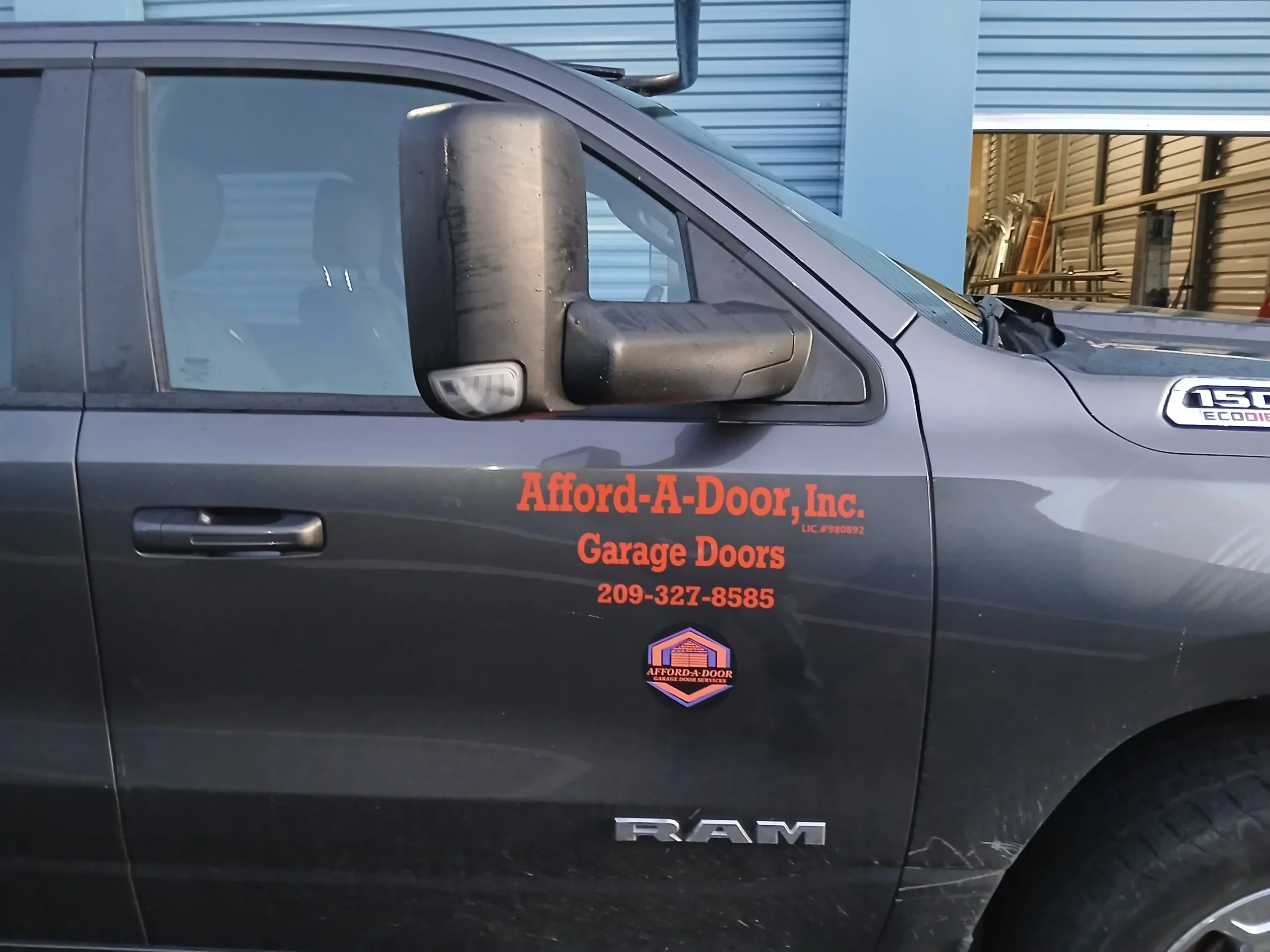 Afford-A-Door Inc. service truck with the company name and phone number on the door