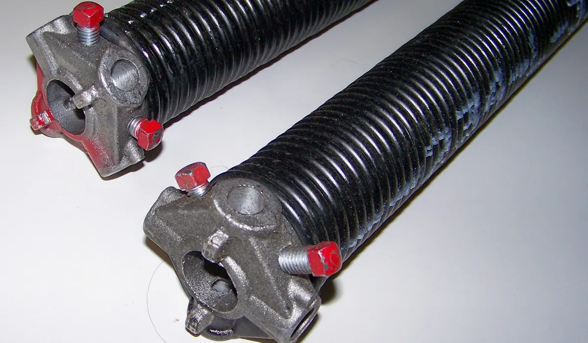 New torsion springs ready to replace a broken garage door spring