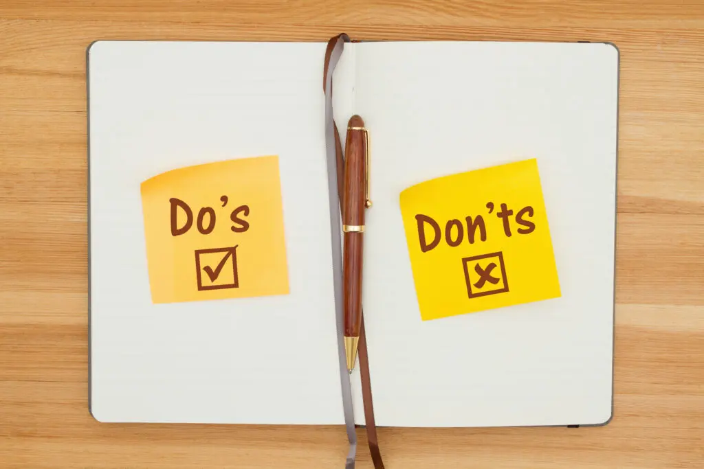 Do's and Don'ts on two sticky notes in a journal with a pen on textured wood desk