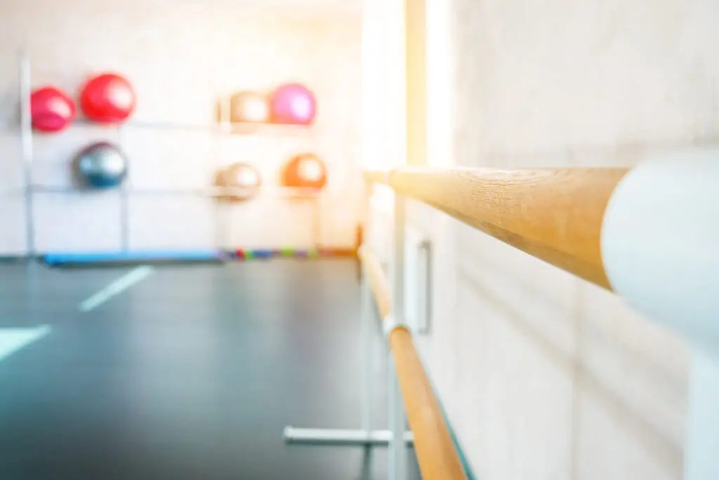 Ballet barre in the choreographic class. Blurred background.
