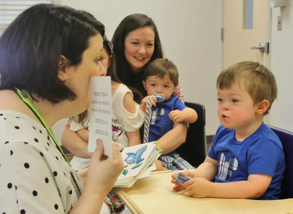 A child receives therapy in Ability Clinic as his mom and siblings look on