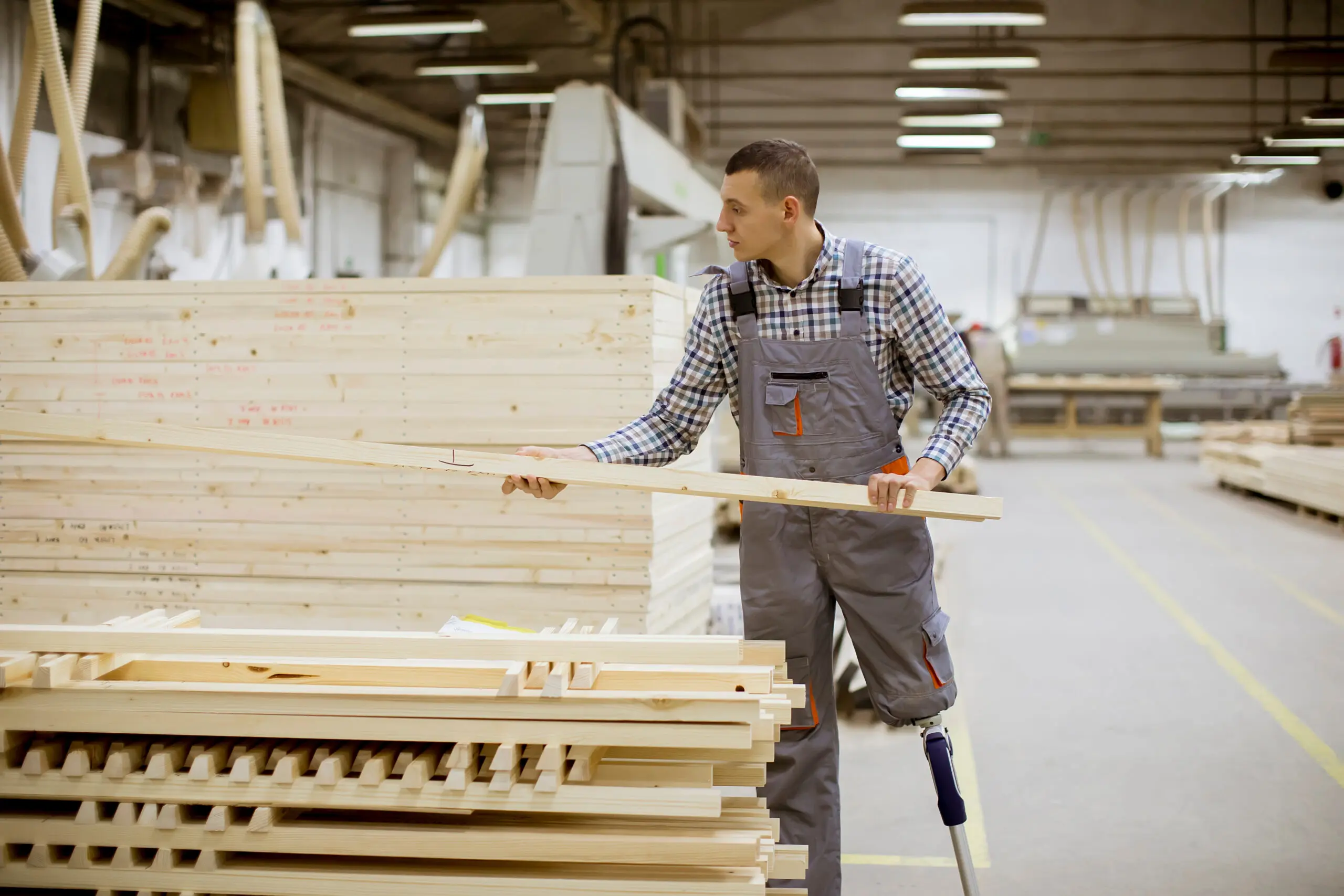 Amputee with an artificial leg working at a furniture factory