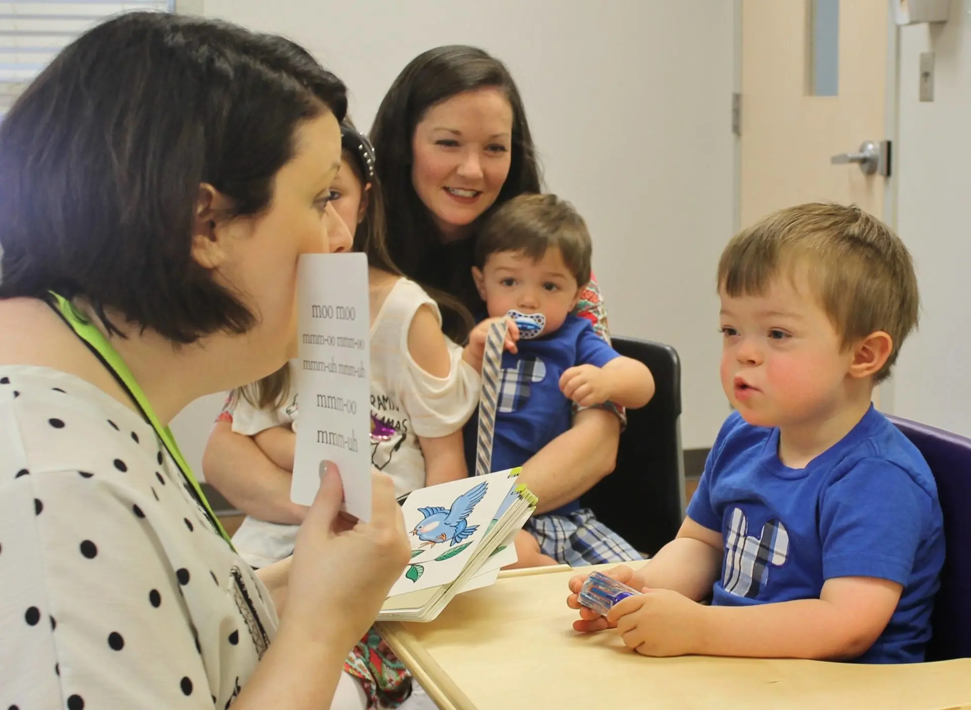 A child receives therapy in Ability Clinic as his mom and siblings look on