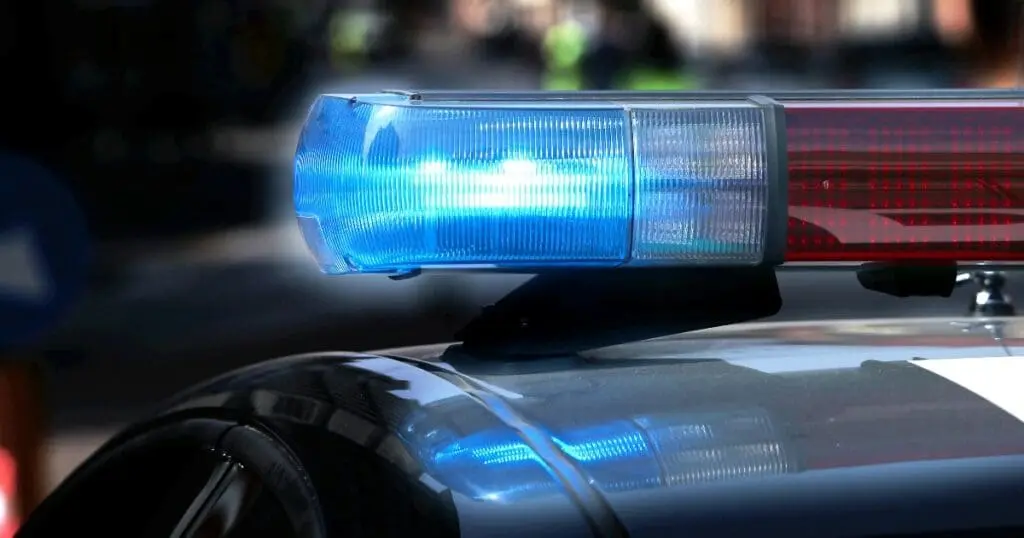 zoomed in top view of a security patrol car with a blue flashing light