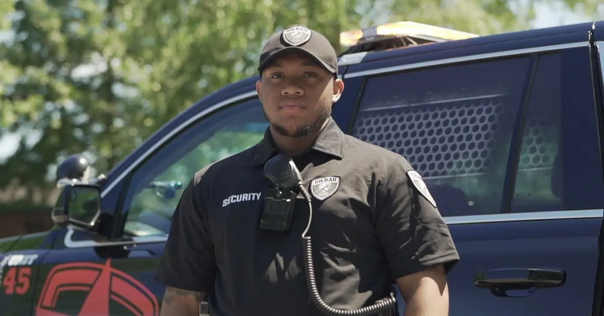 silbar security guard standing in front of a patrol car