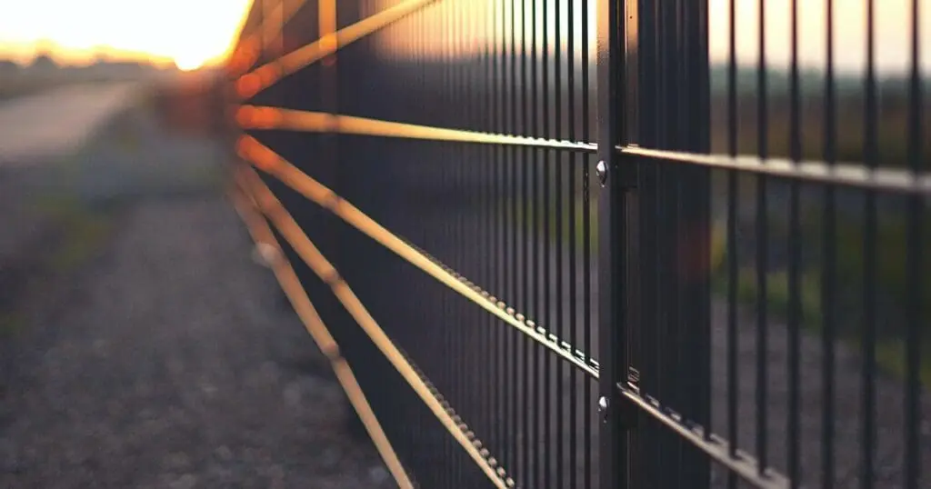 black metal fence with a sunset in the background