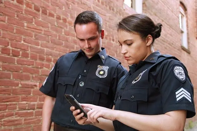 guards looking at phone
